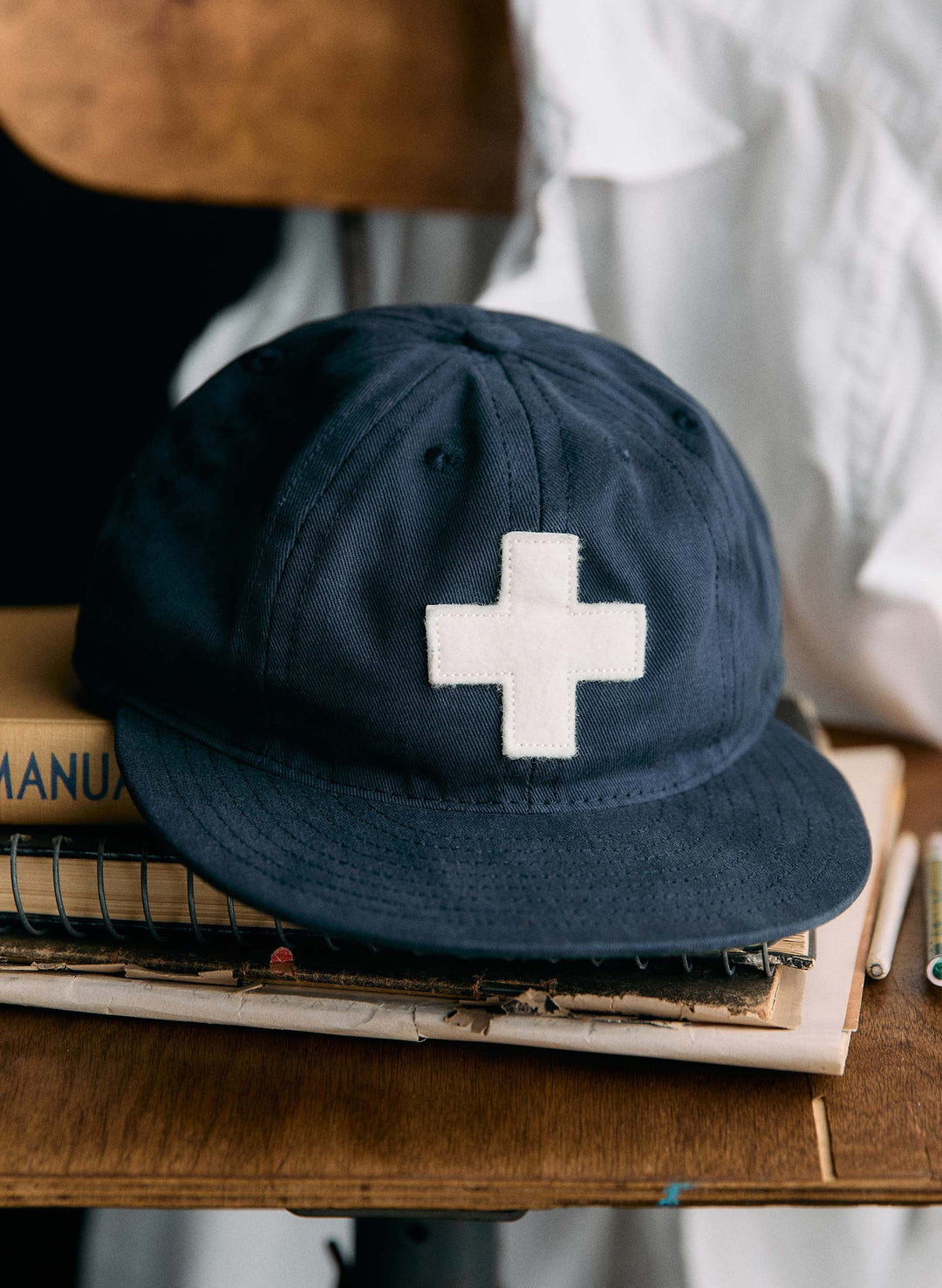 a blue hat with a white cross on it