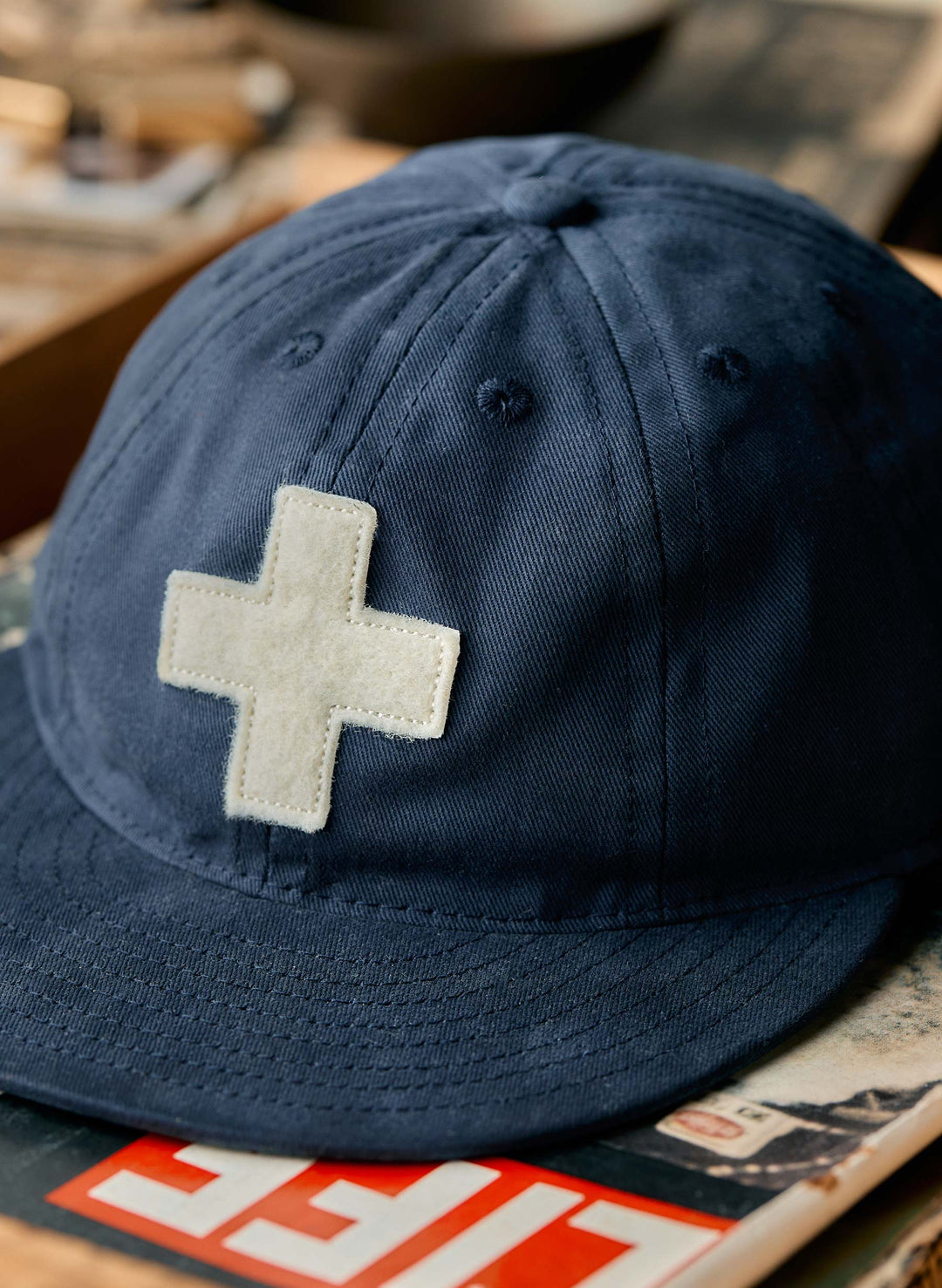 a blue hat with a white cross on it