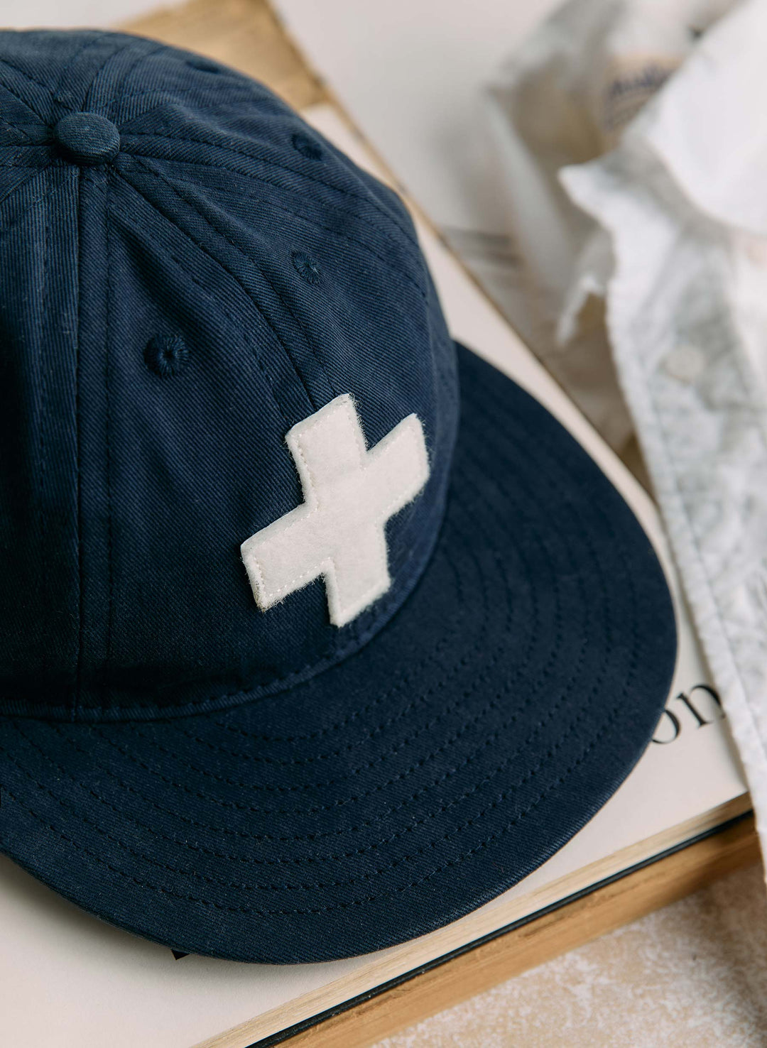 a blue hat with a white cross on it