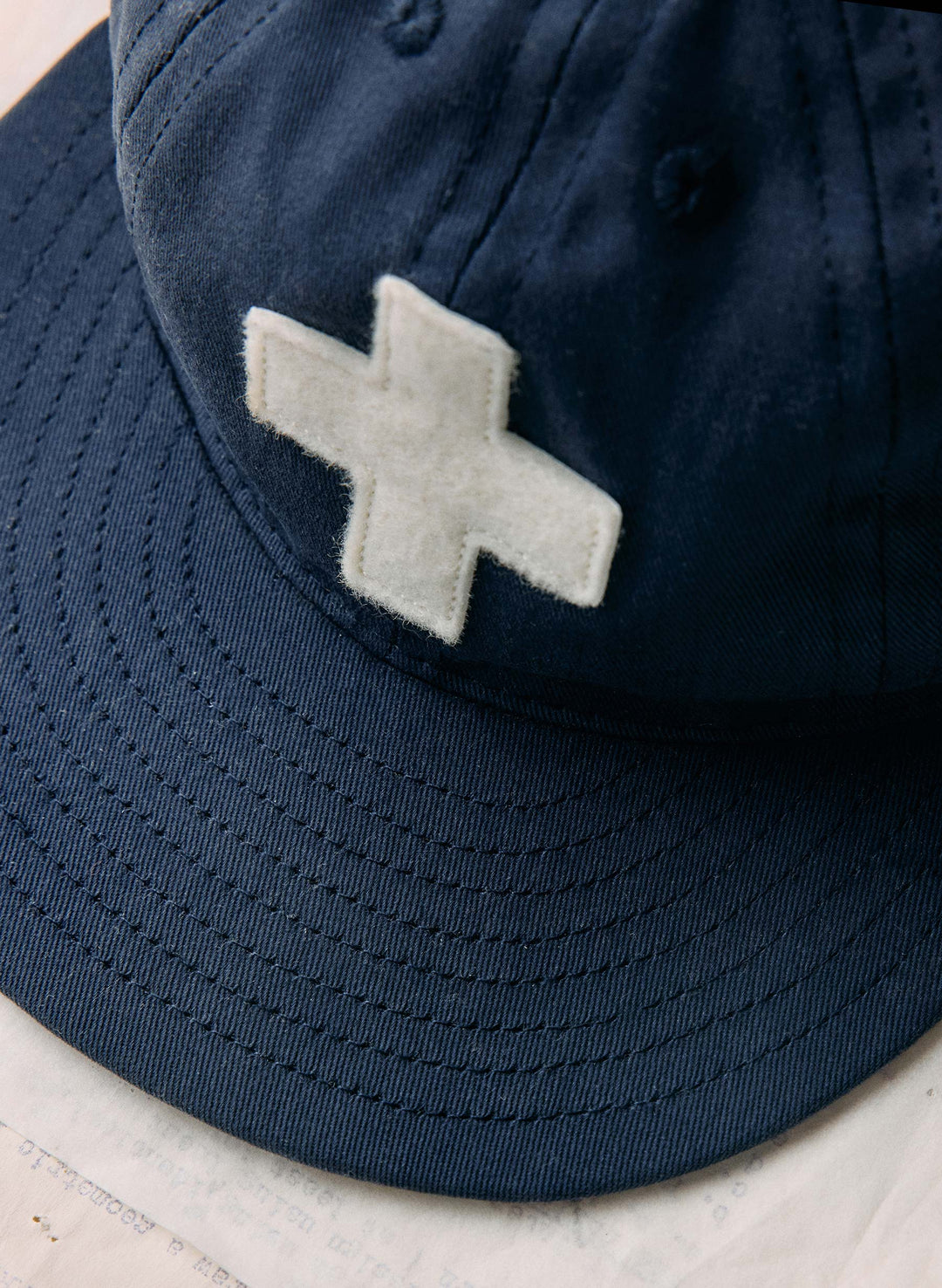 a blue hat with a white cross on it