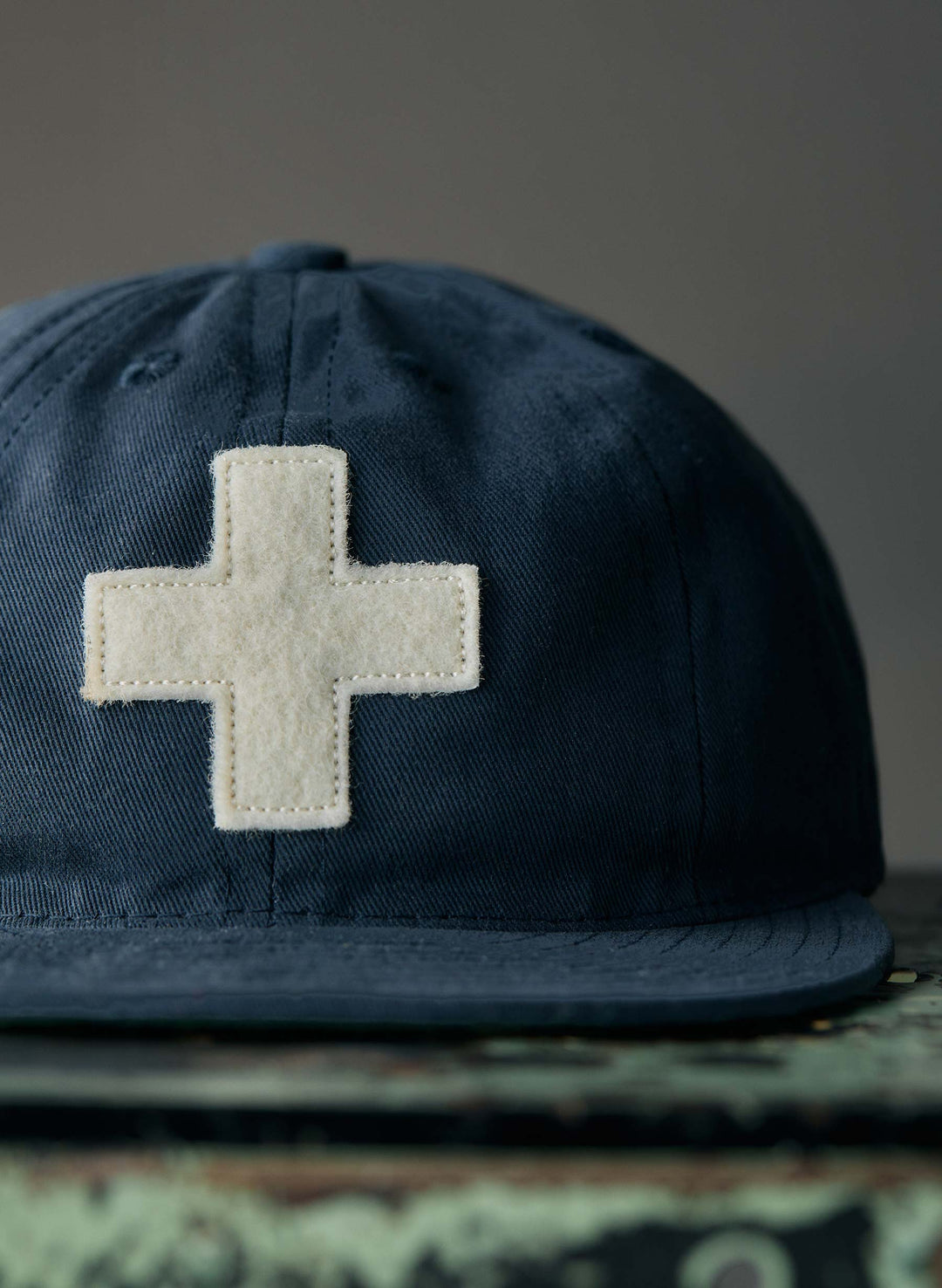 a blue hat with a white cross on it