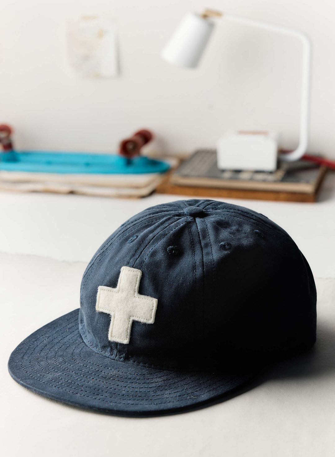 a blue hat with a white cross on it