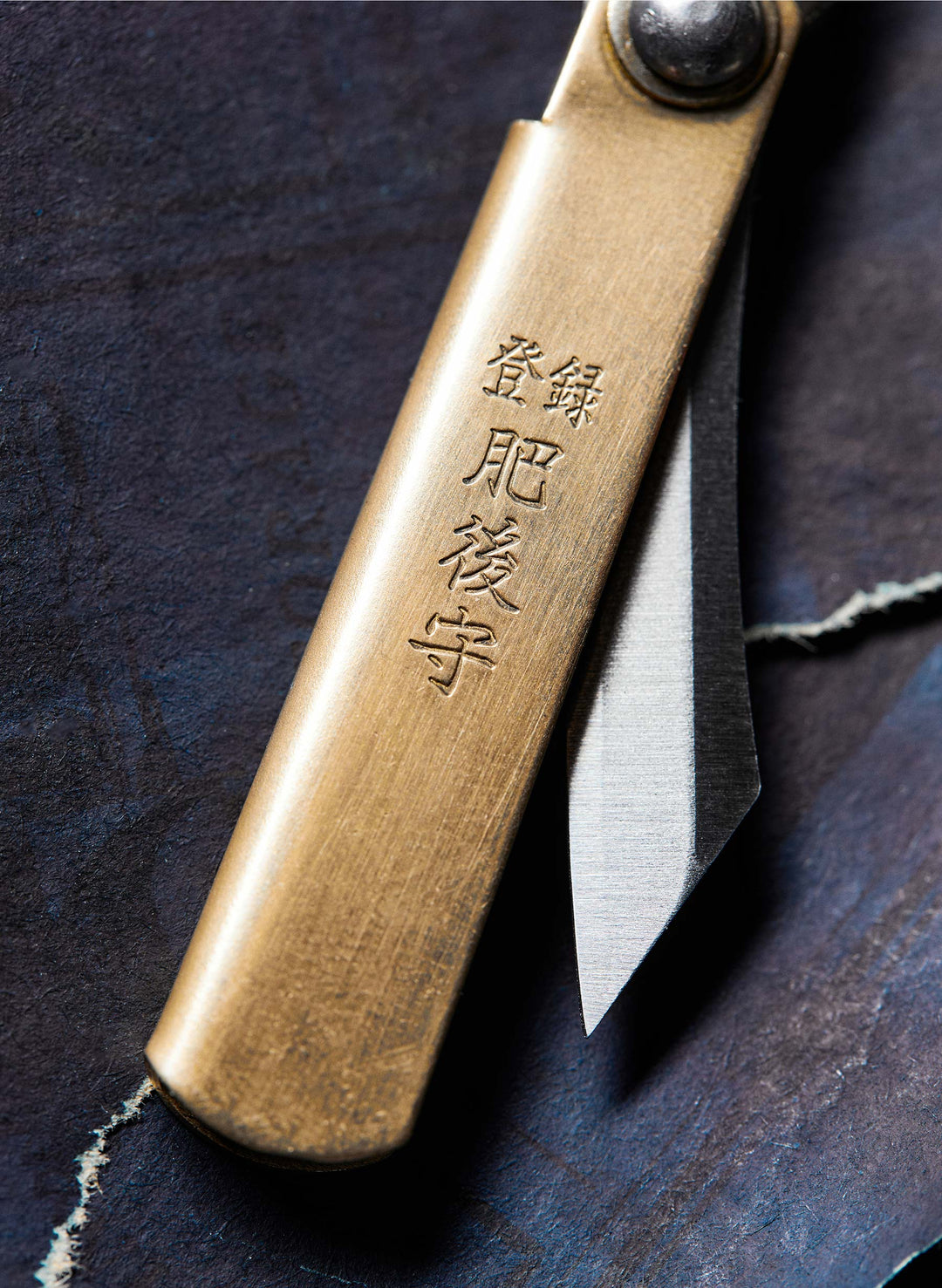 a gold knife with a silver blade