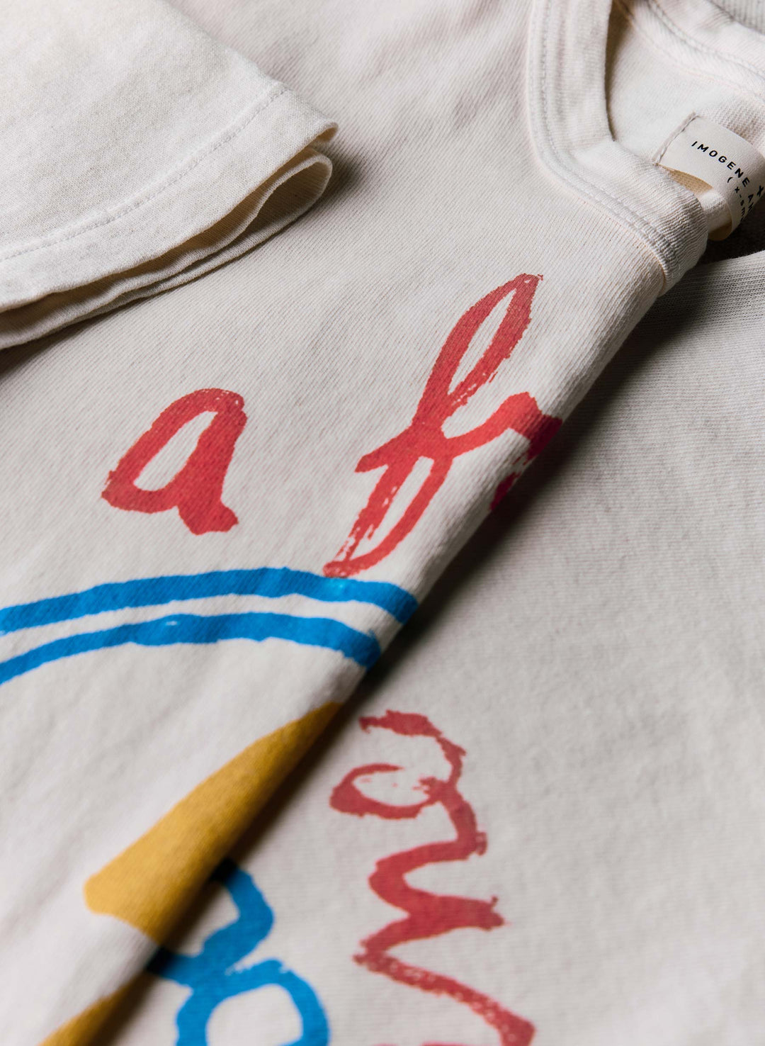 a white t-shirt with red writing on it