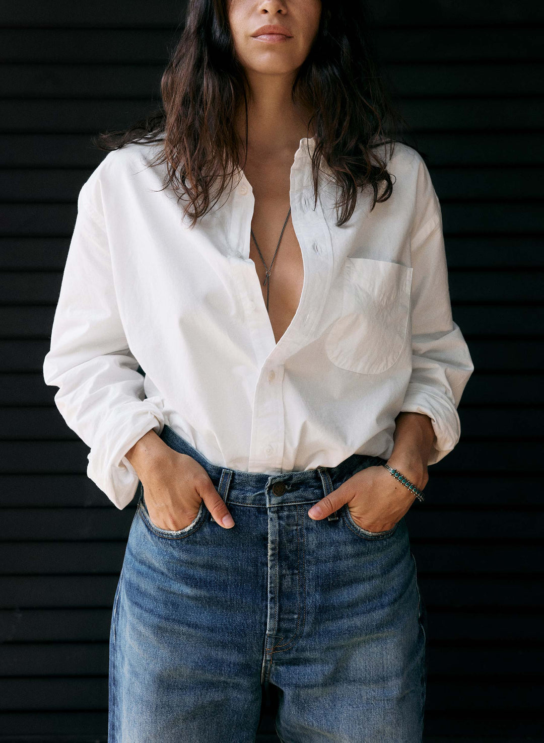 a woman wearing a white shirt and blue jeans