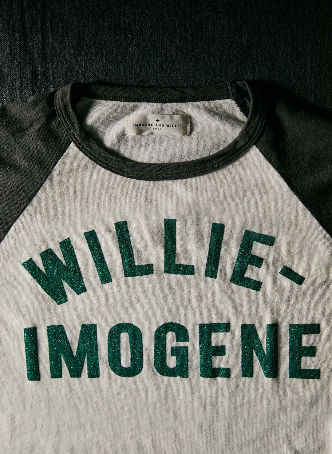 a black and white shirt with green letters