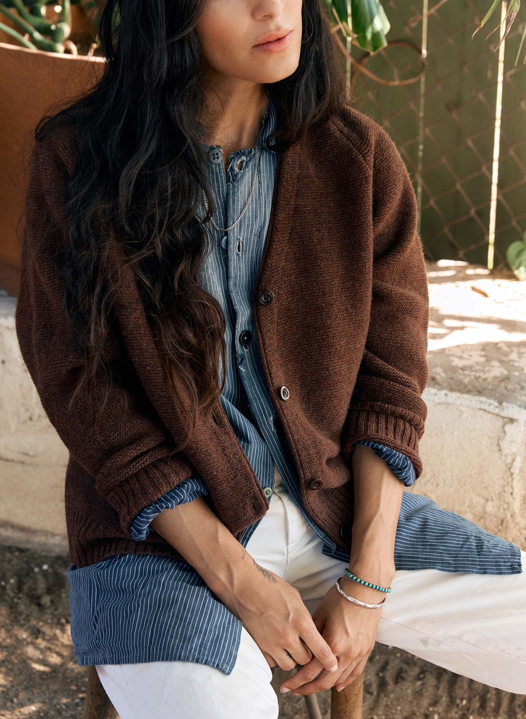 a person sitting on a ledge