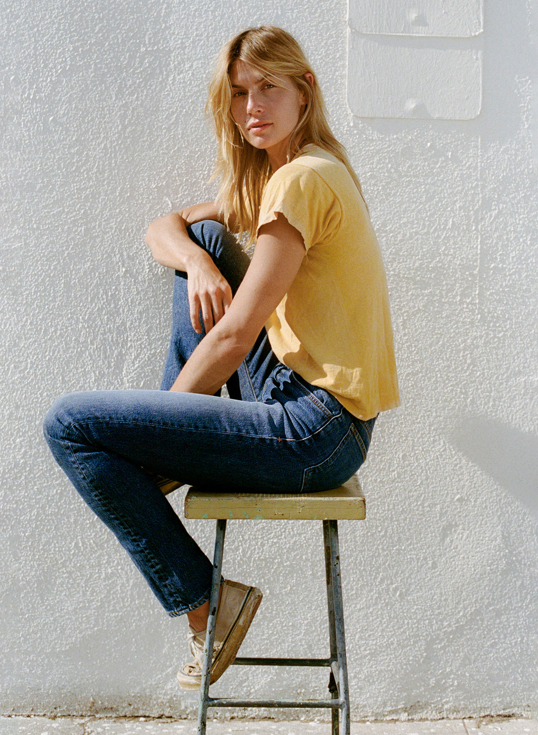 a woman sitting on a stool