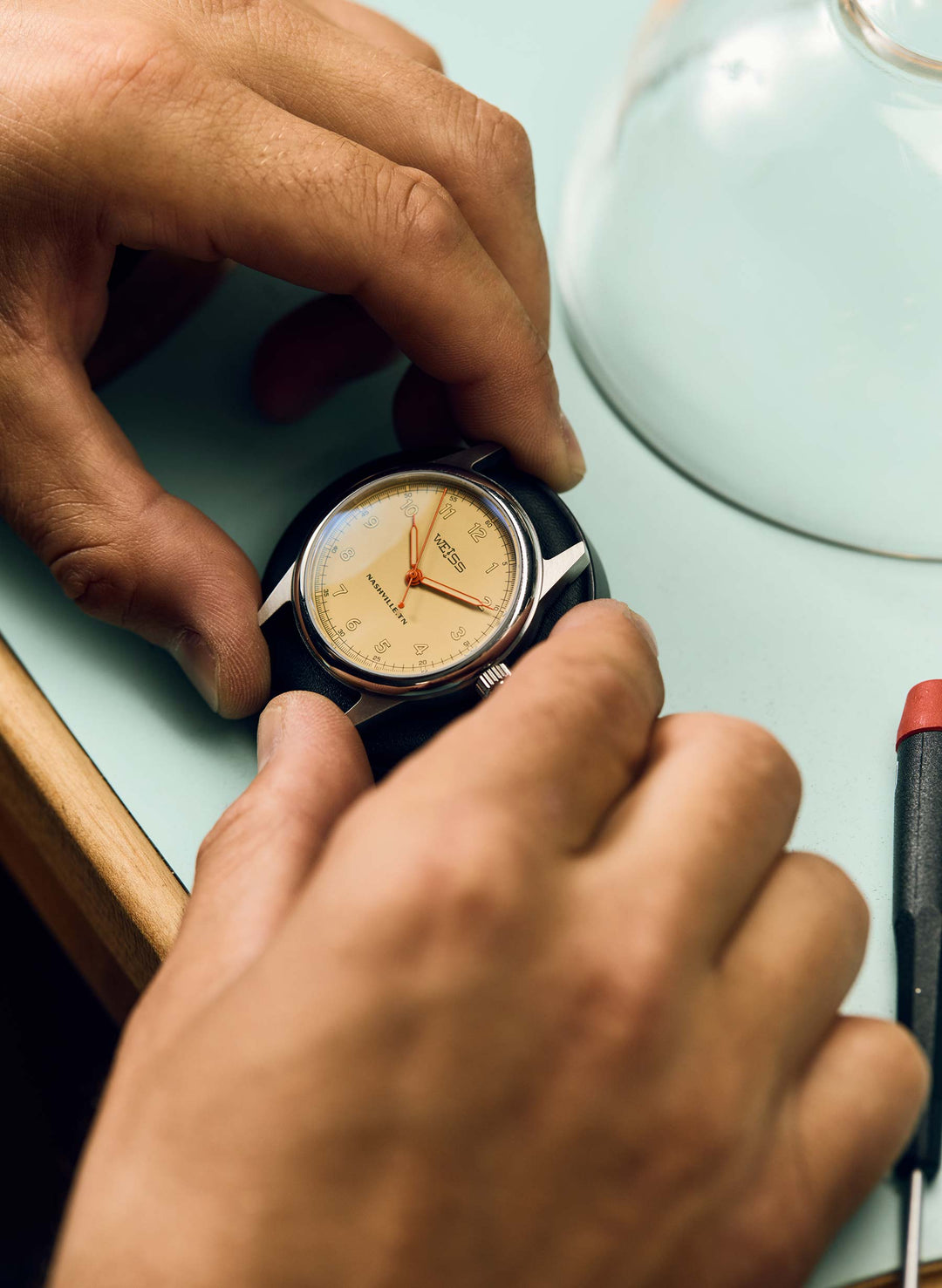 a person's hands holding a watch