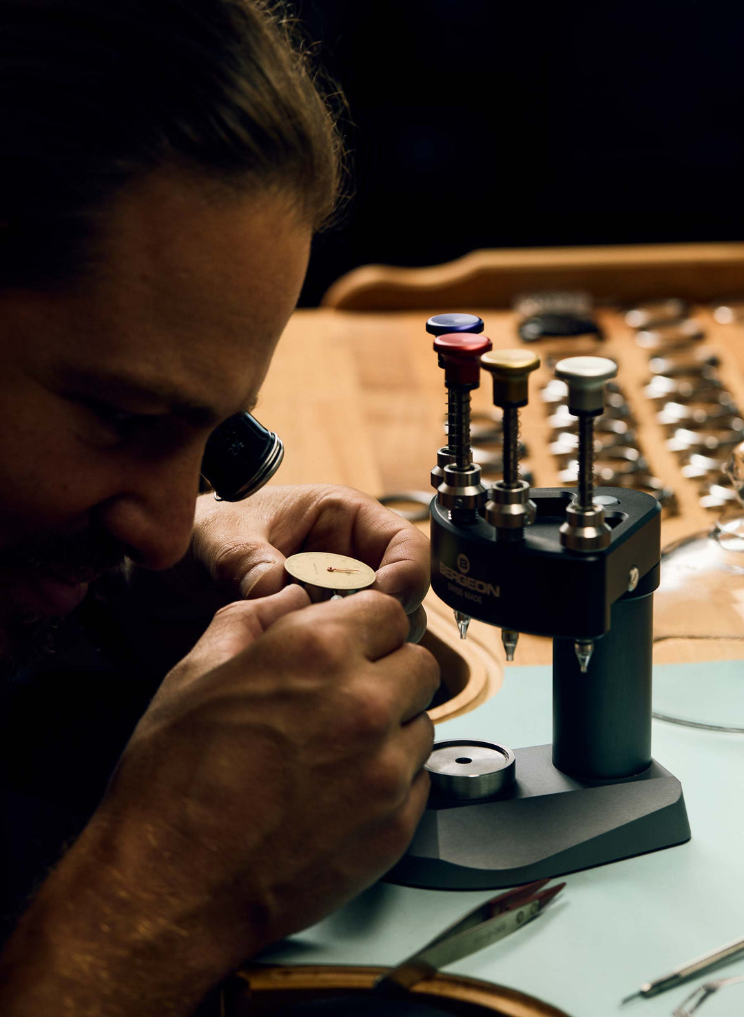 a man using a magnifying glass to make a piece of wood