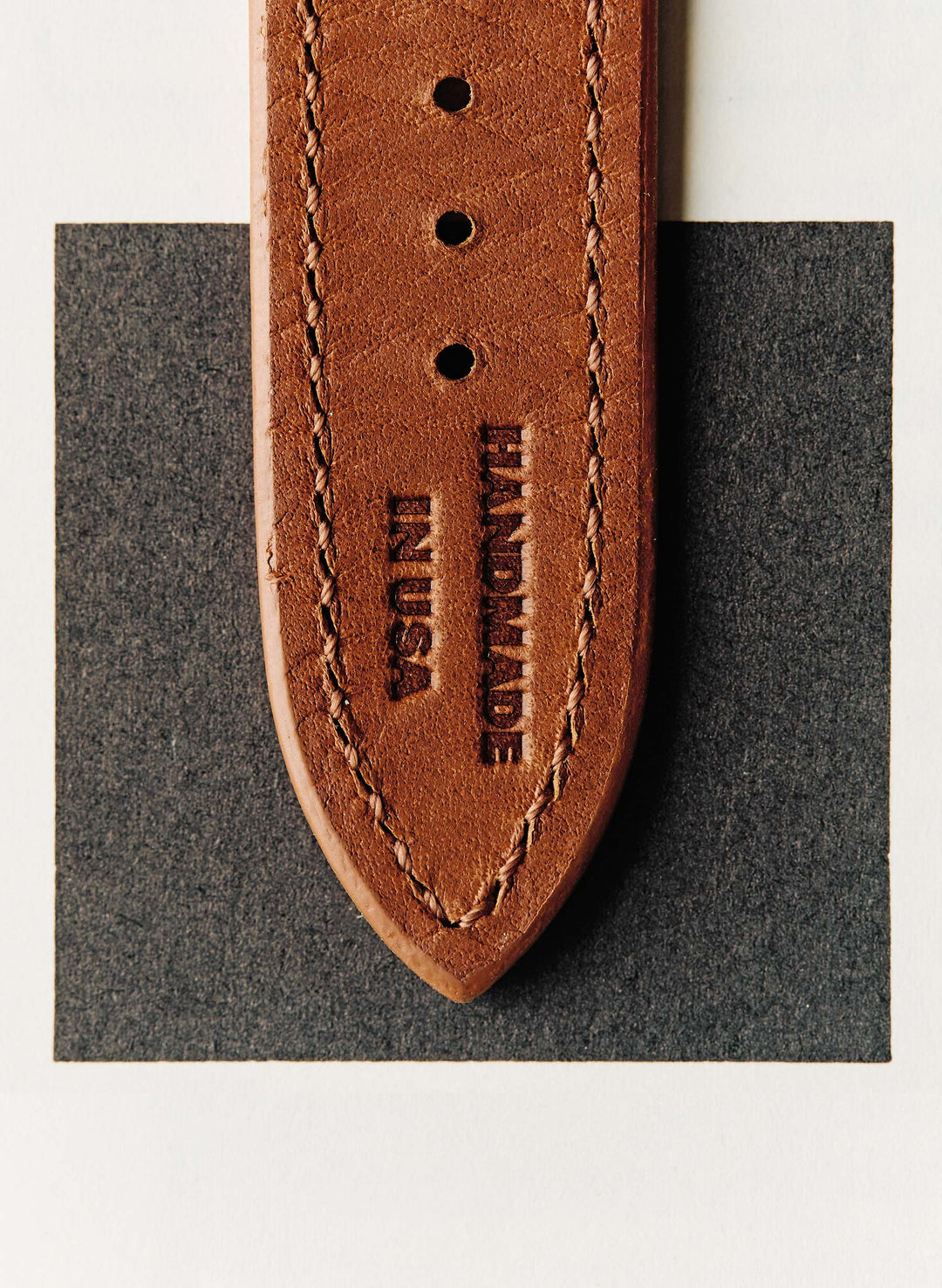 a brown leather belt with black text