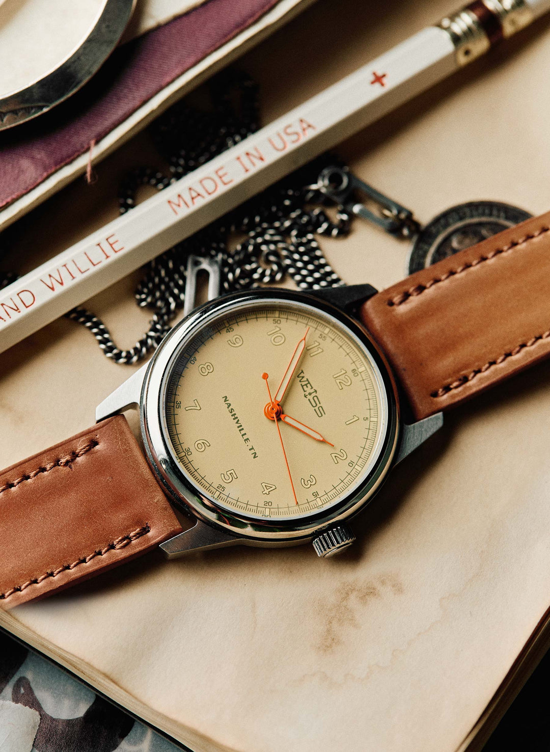 a watch with leather straps and chain