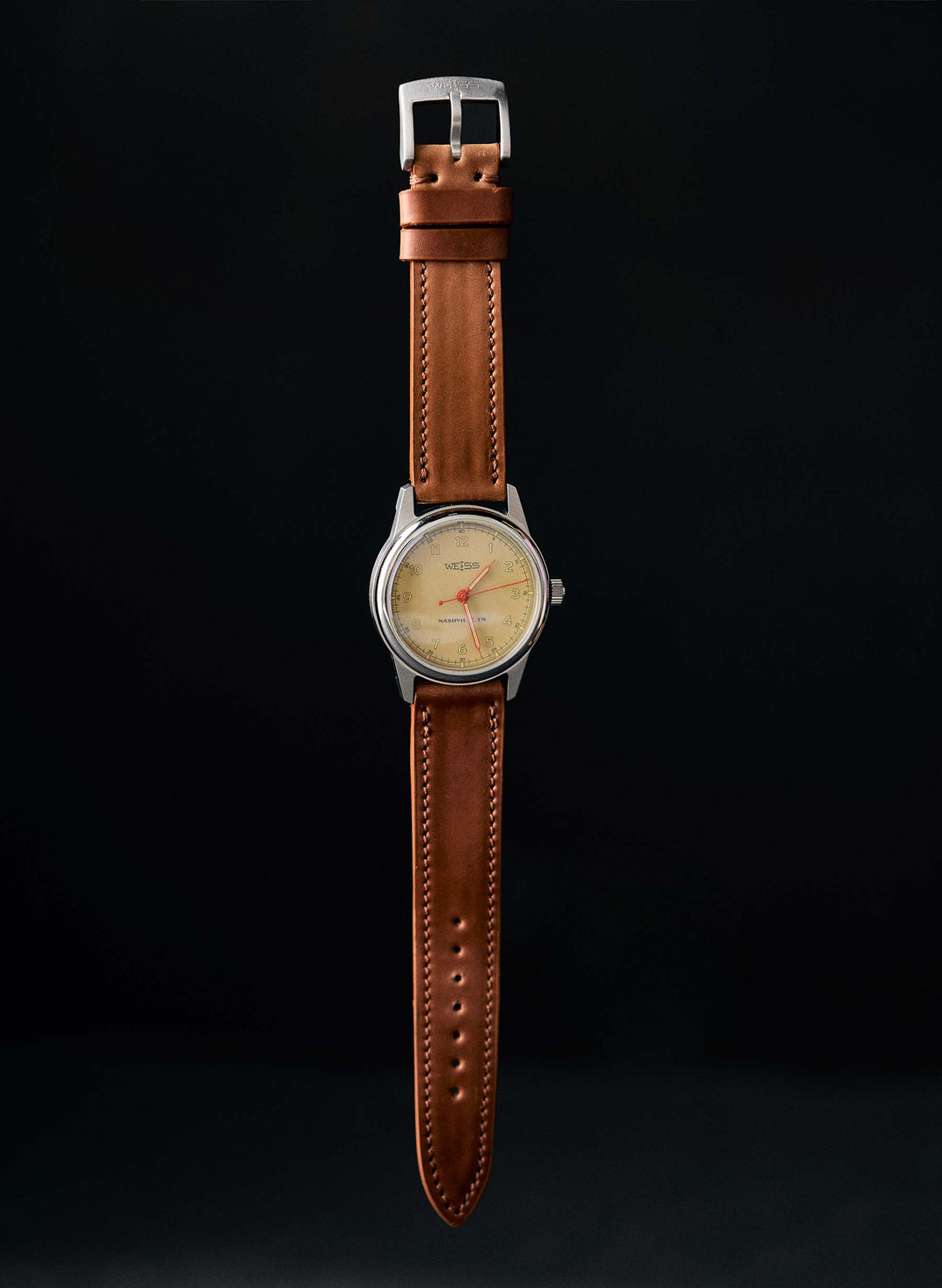 a watch with a brown strap