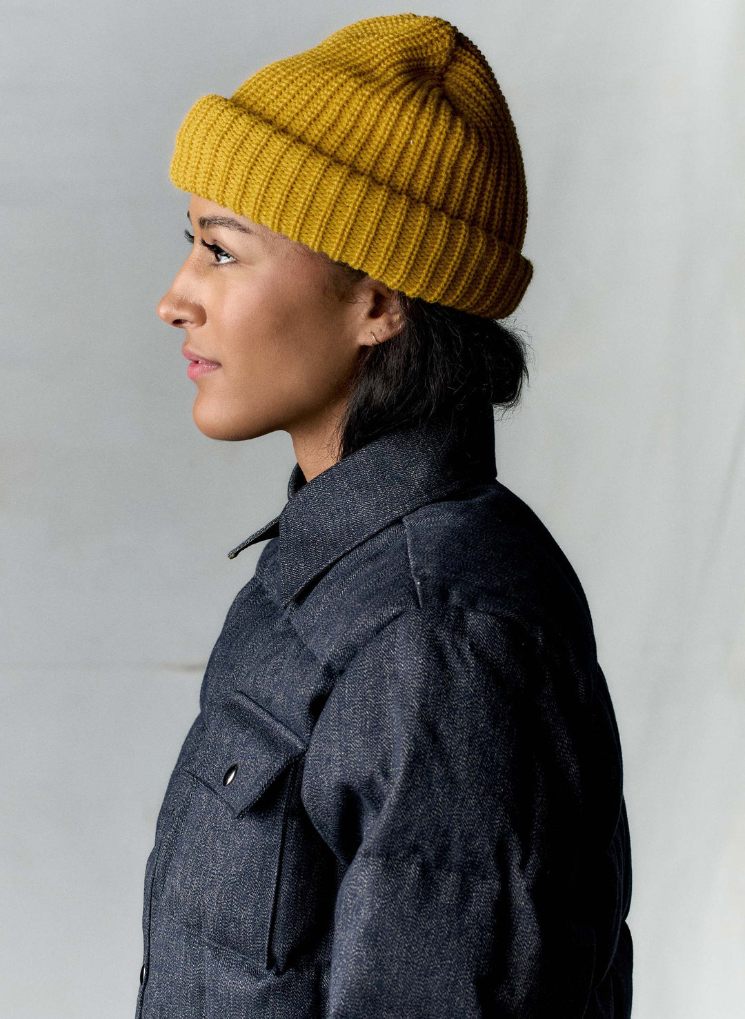 a woman wearing a yellow beanie