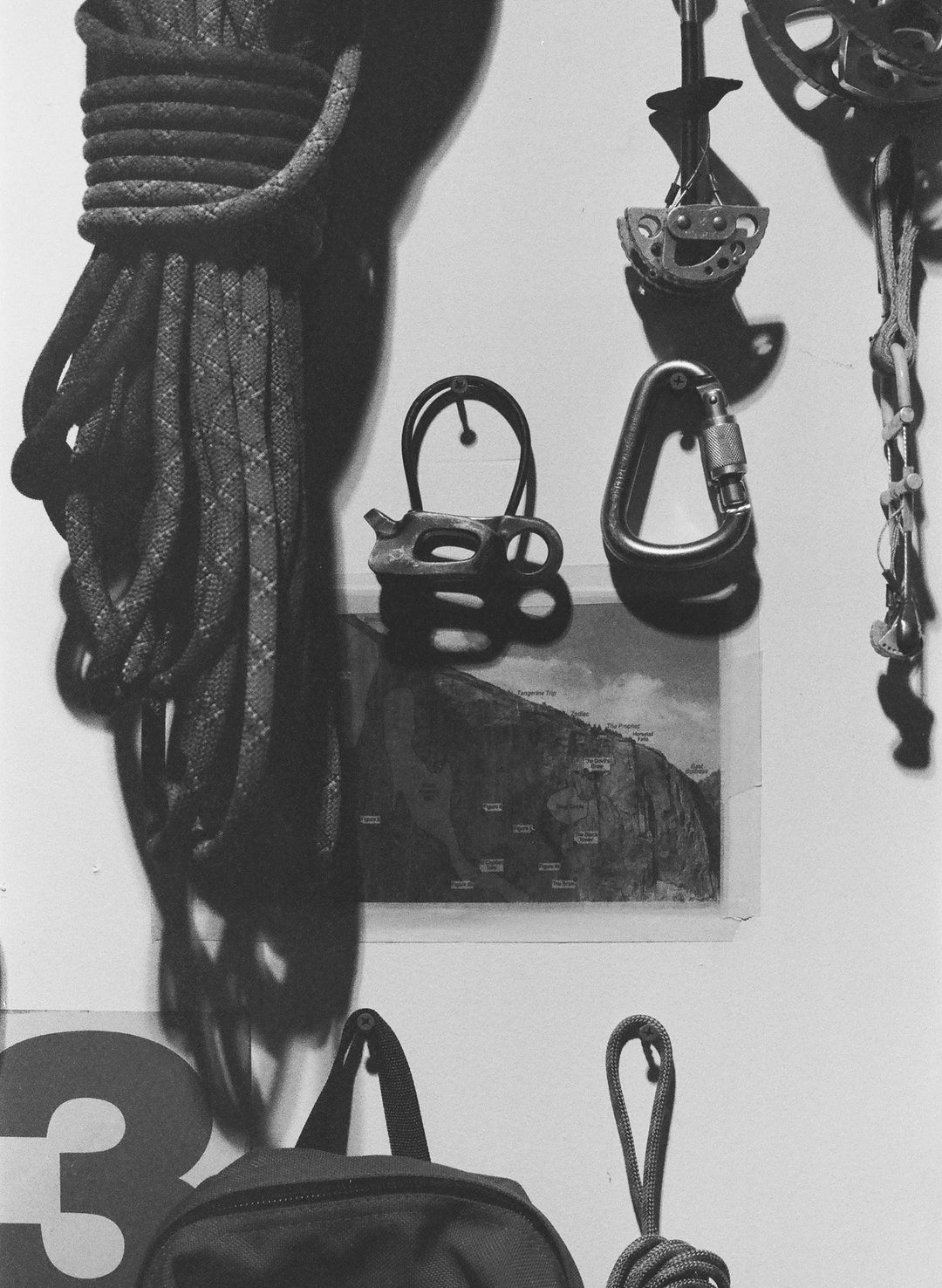 a rope and carabiners on a wall