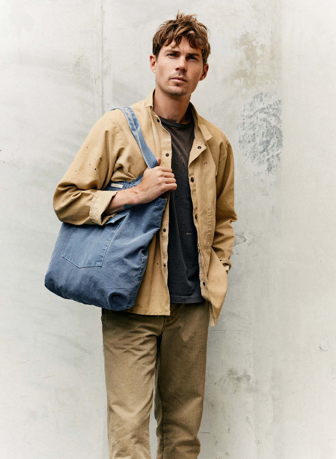 a man holding a blue bag