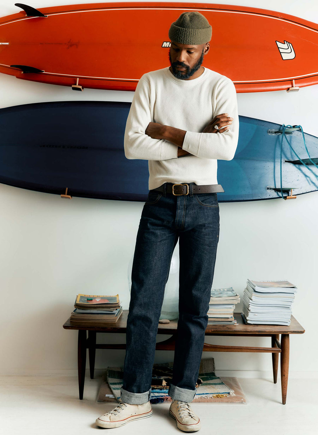 a man standing in front of a surfboard