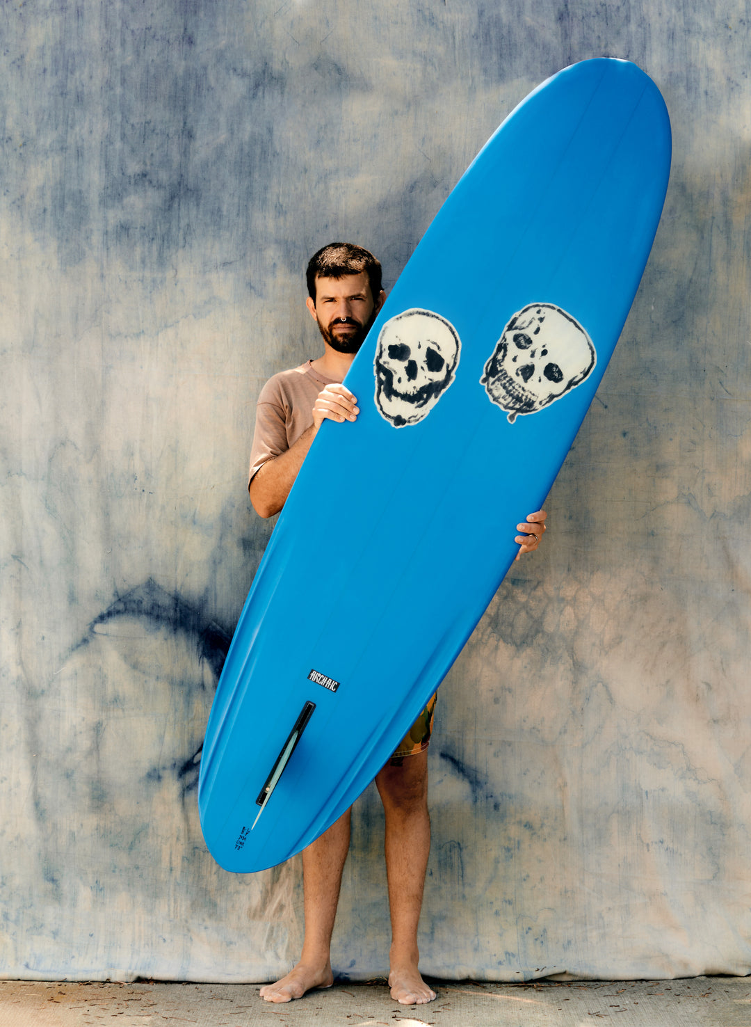 a man holding a blue surfboard