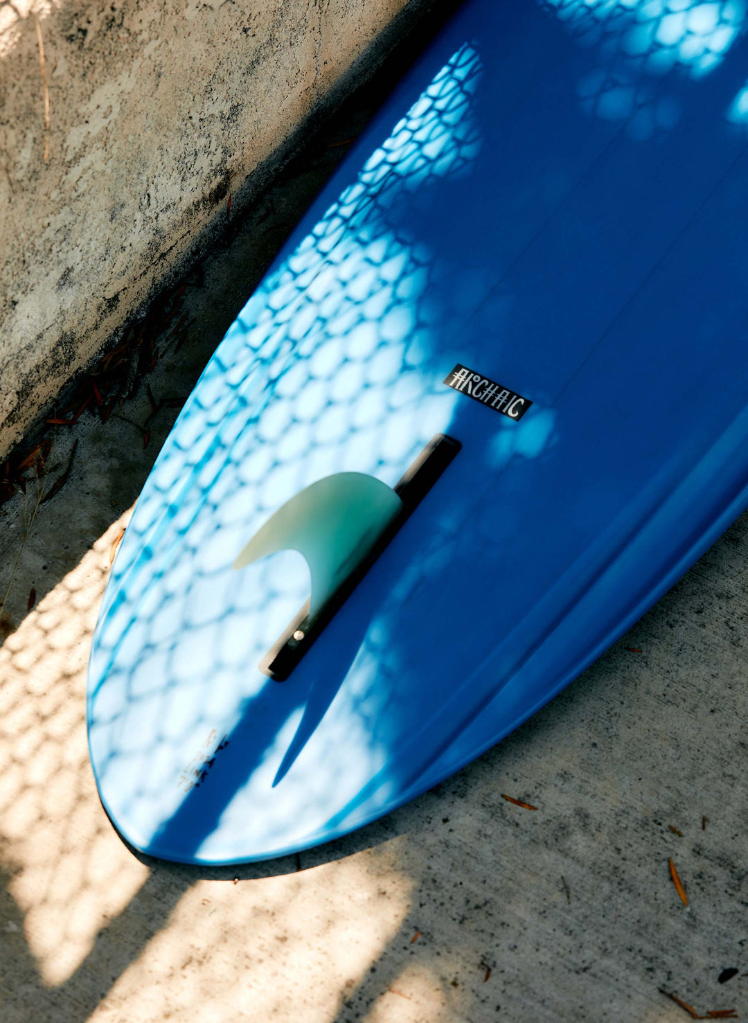 a blue surfboard on the ground