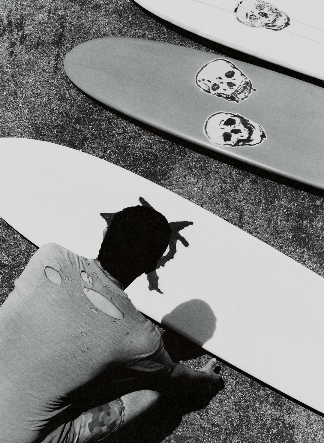 a man looking at a surfboard