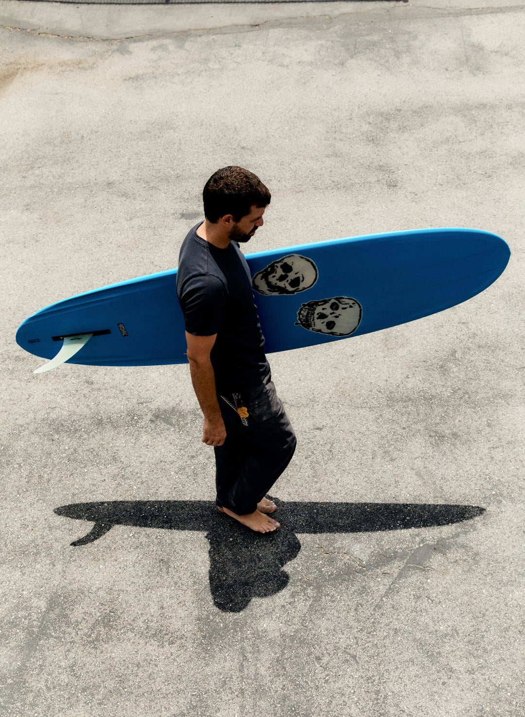 a man carrying a surfboard