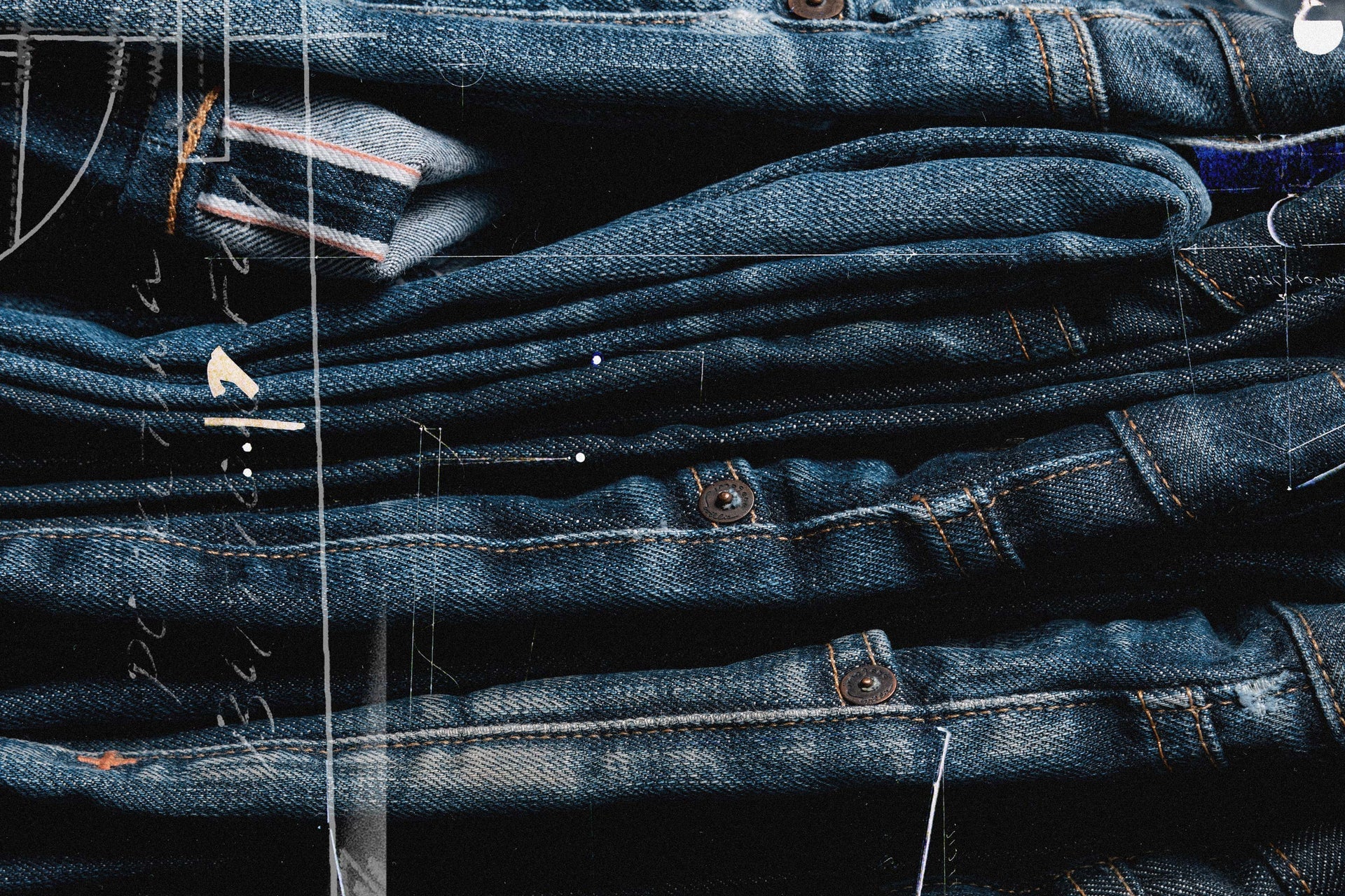 a stack of jeans with clothes pegs
