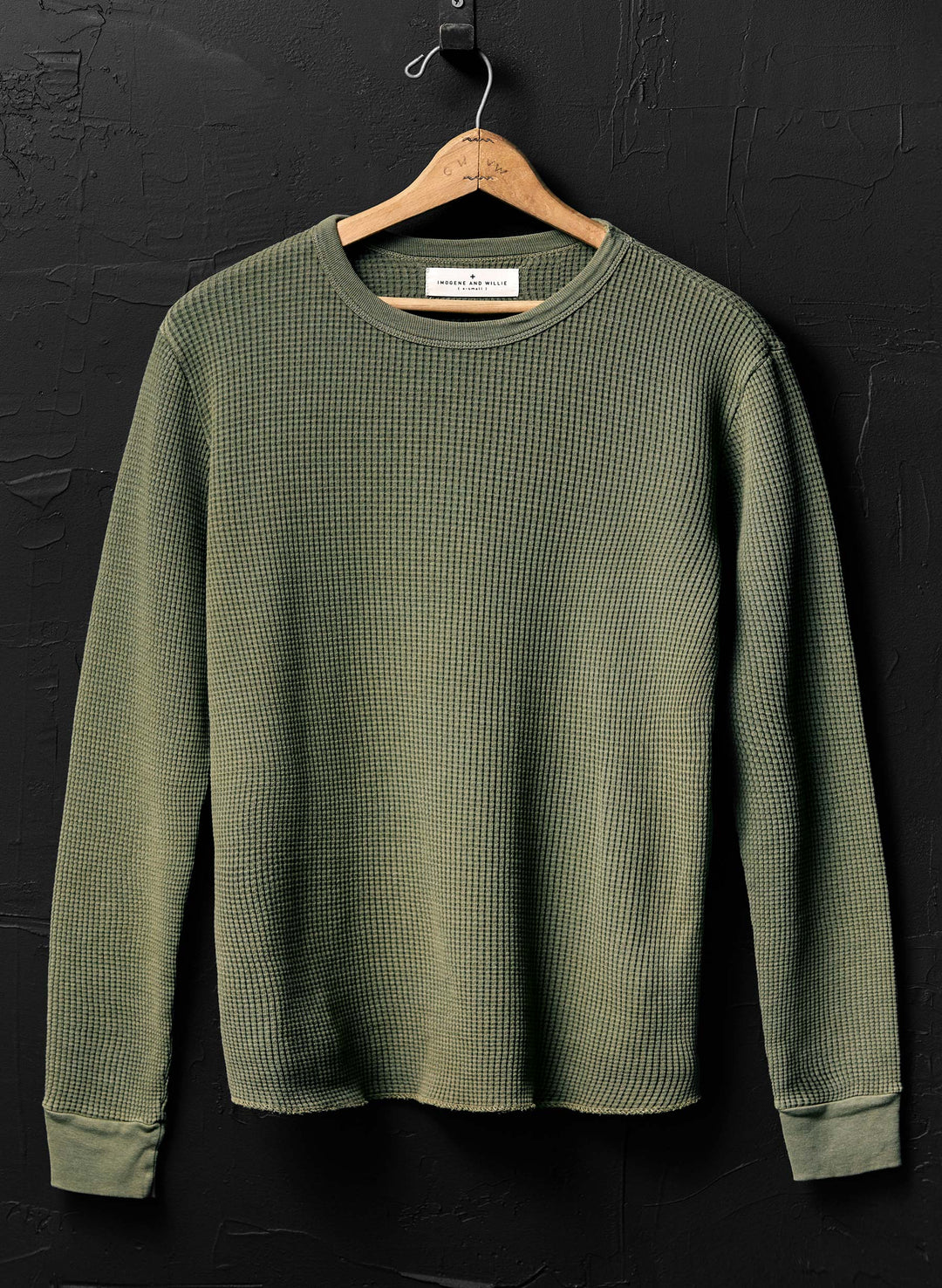 a green sweater on a swinger