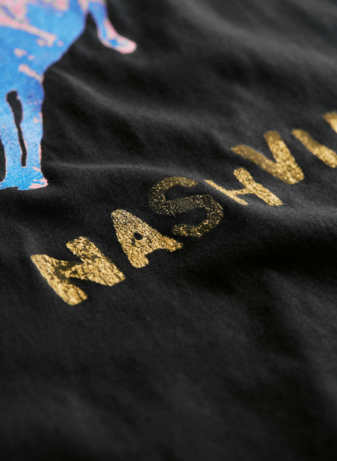 a close up of a black fabric with gold text