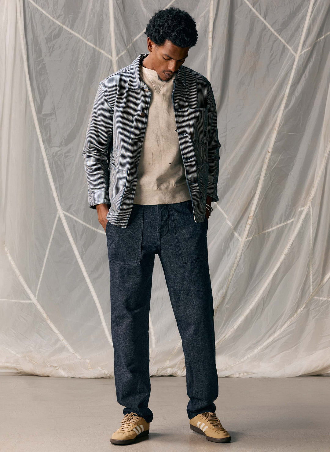 a man standing in front of a white curtain