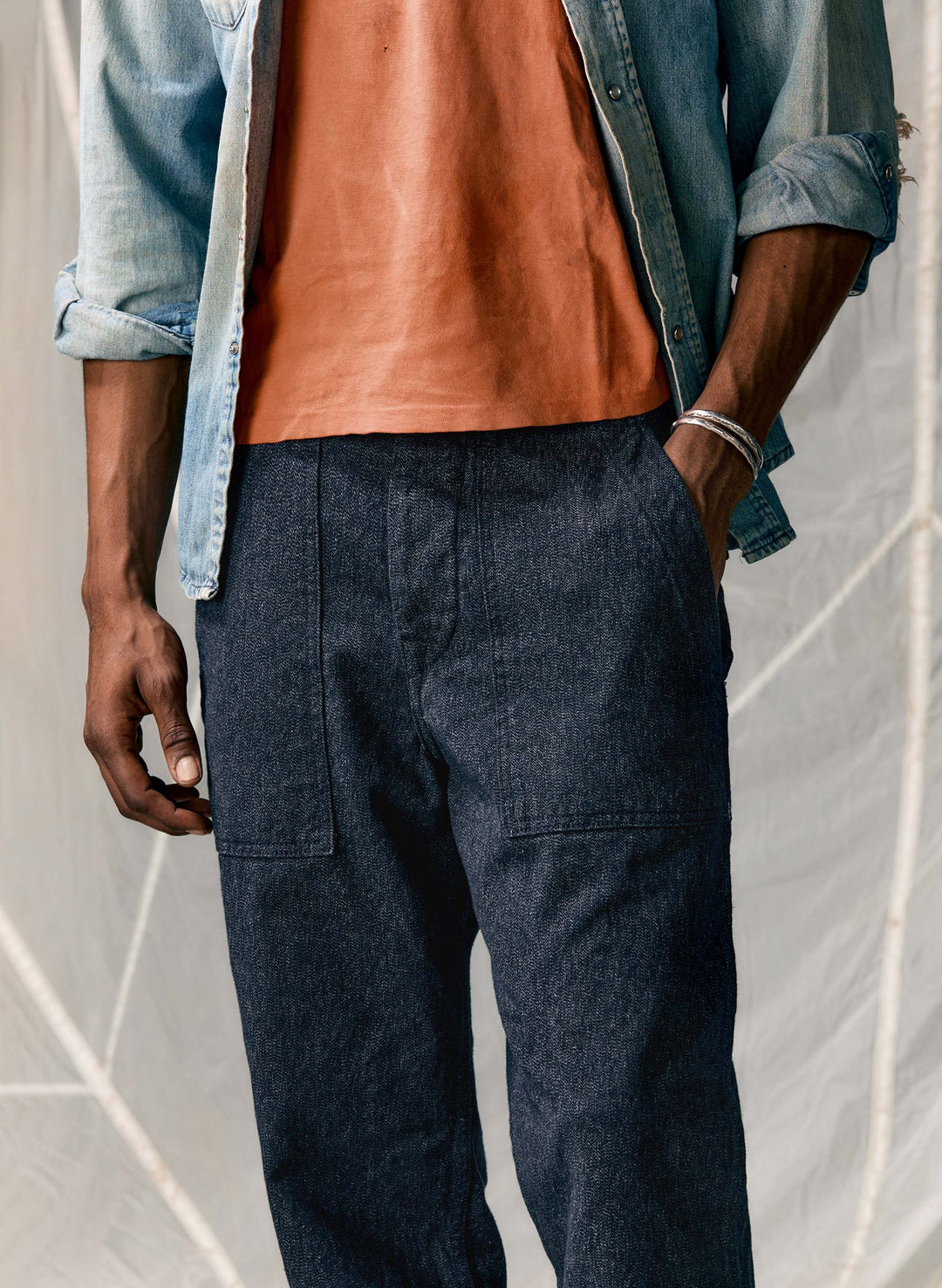 a man wearing a denim jacket and a red shirt