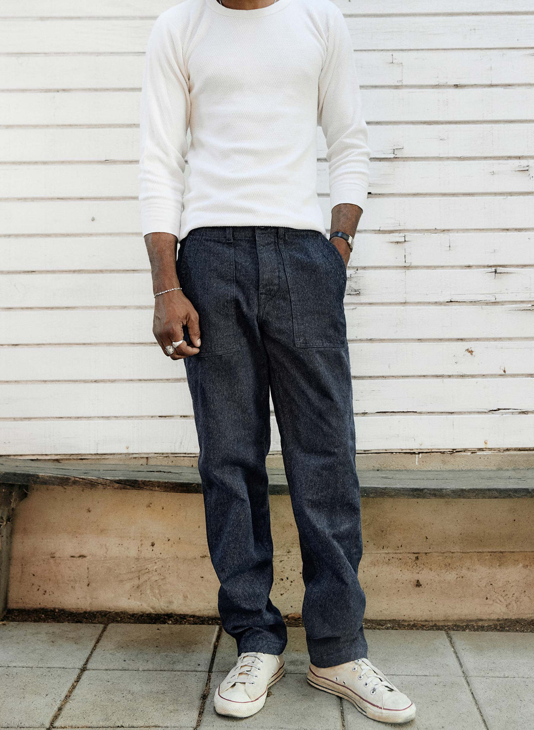 a man standing in front of a white wall