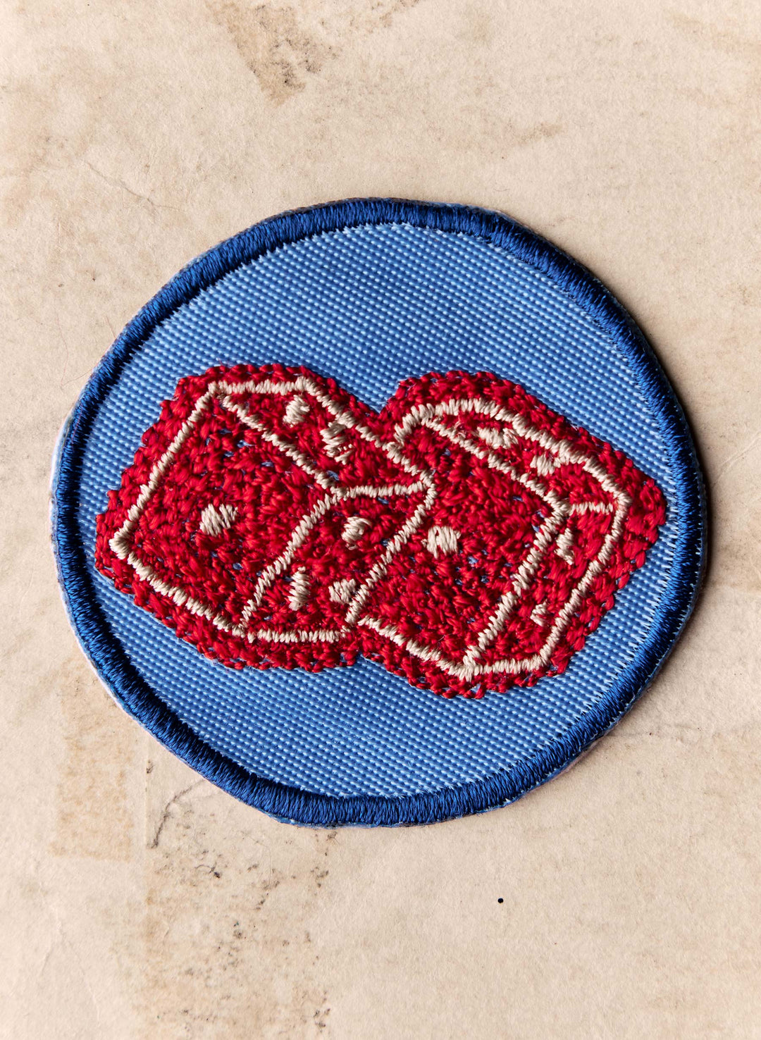 a patch with a red and white design on it