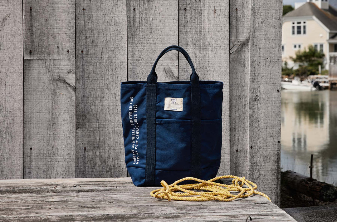 a blue bag with a yellow rope on a wooden surface