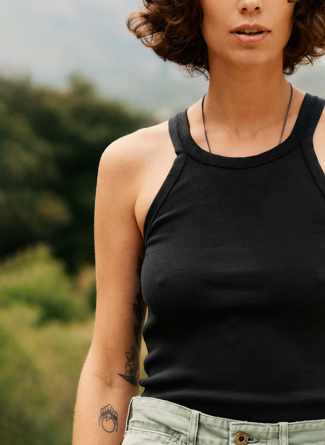 a woman wearing a black tank top