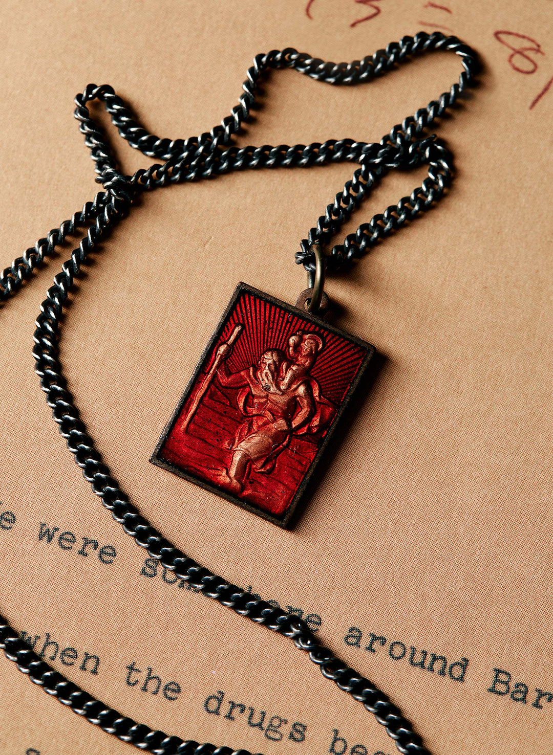 a red pendant on a chain