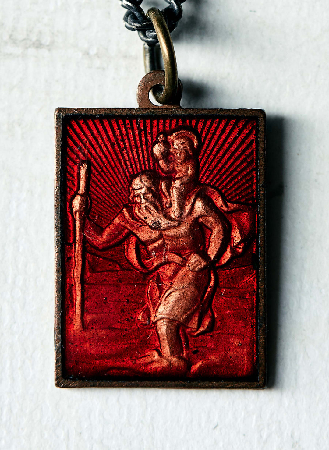 a red and silver medallion with a red background