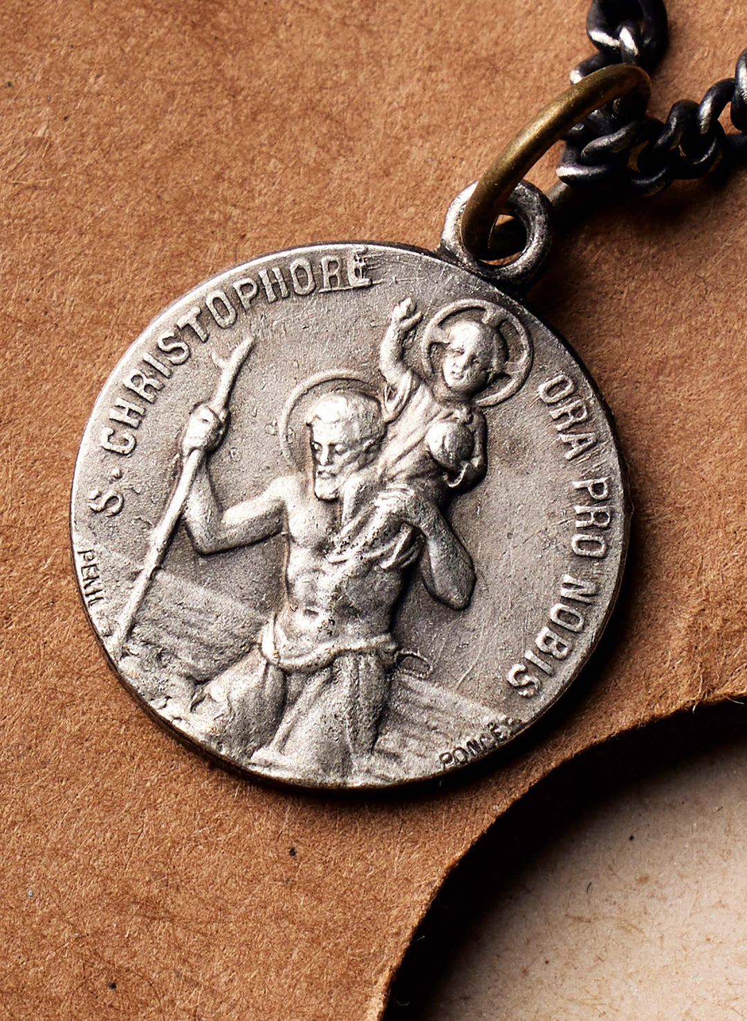 a silver medallion with a chain