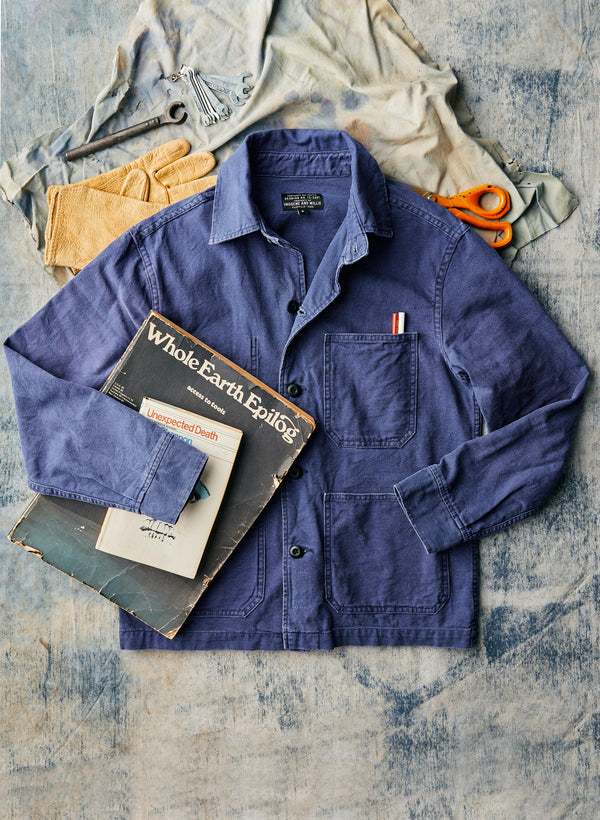 a blue shirt with a pair of scissors and a book