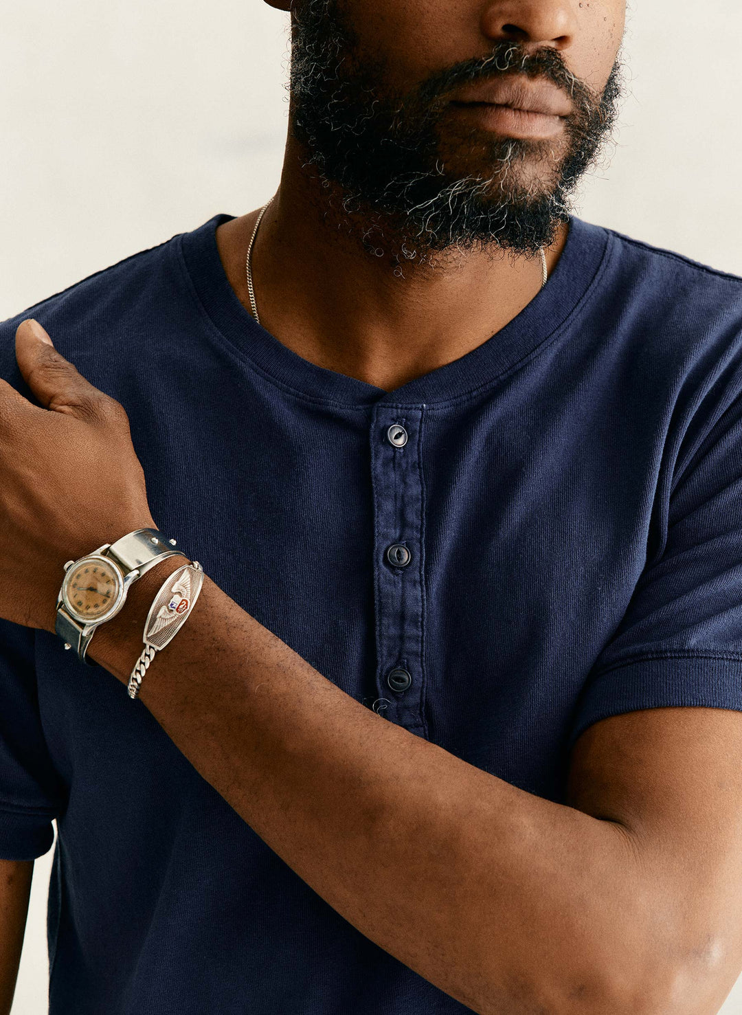 a man wearing a blue shirt and wrist watch