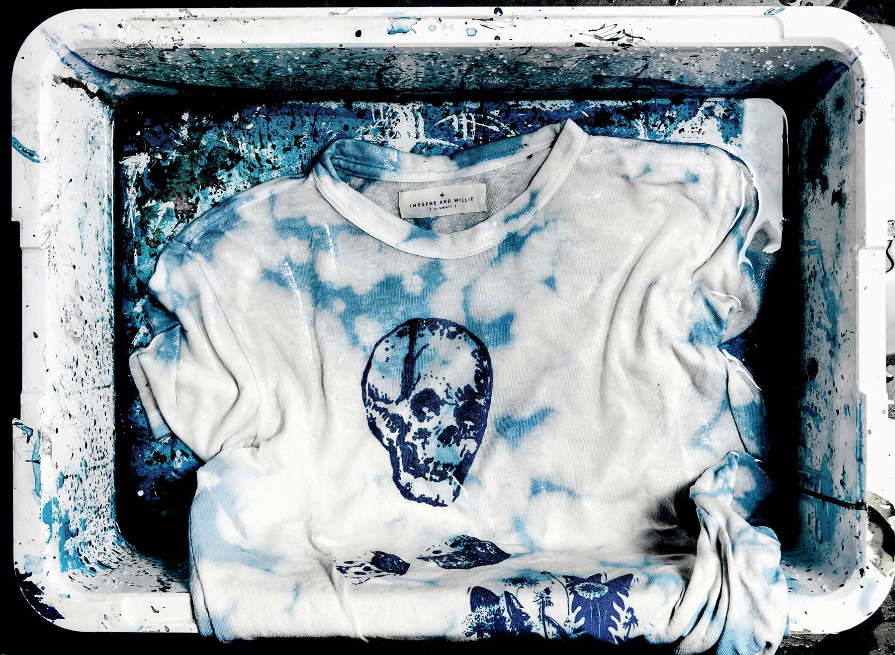 Azure, Rectangle, Sleeve, T-shirt, Dishware, Font, Electric blue, Skull, Pattern, Fashion accessory