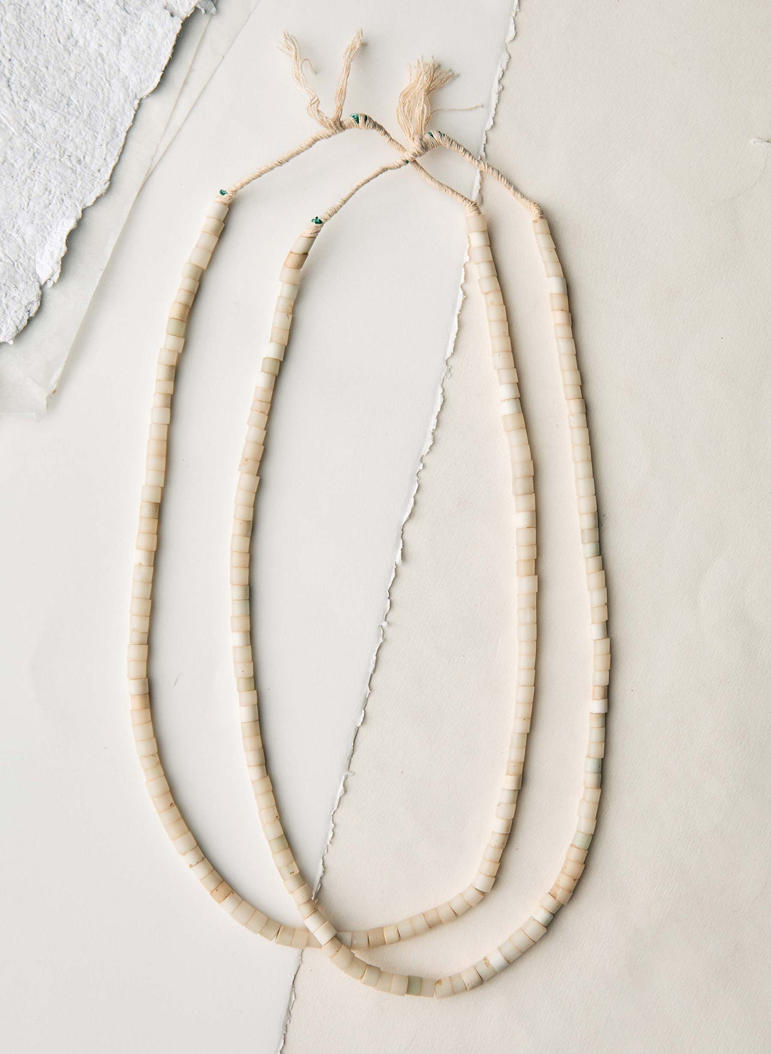 a necklace on a white surface