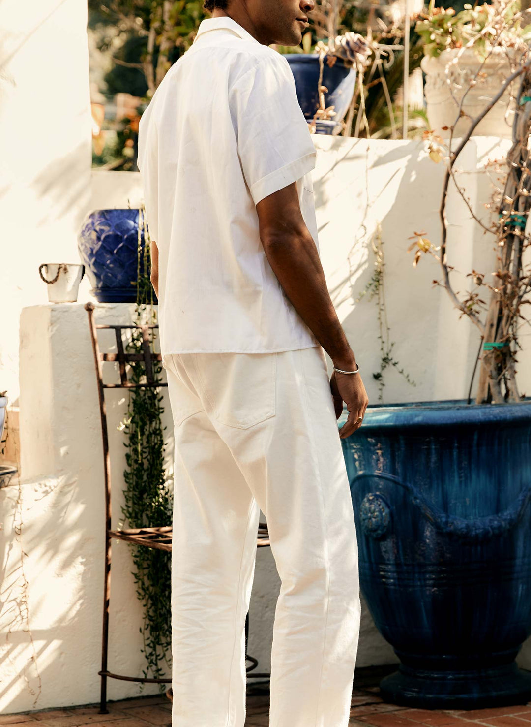 a man in white shirt and white pants