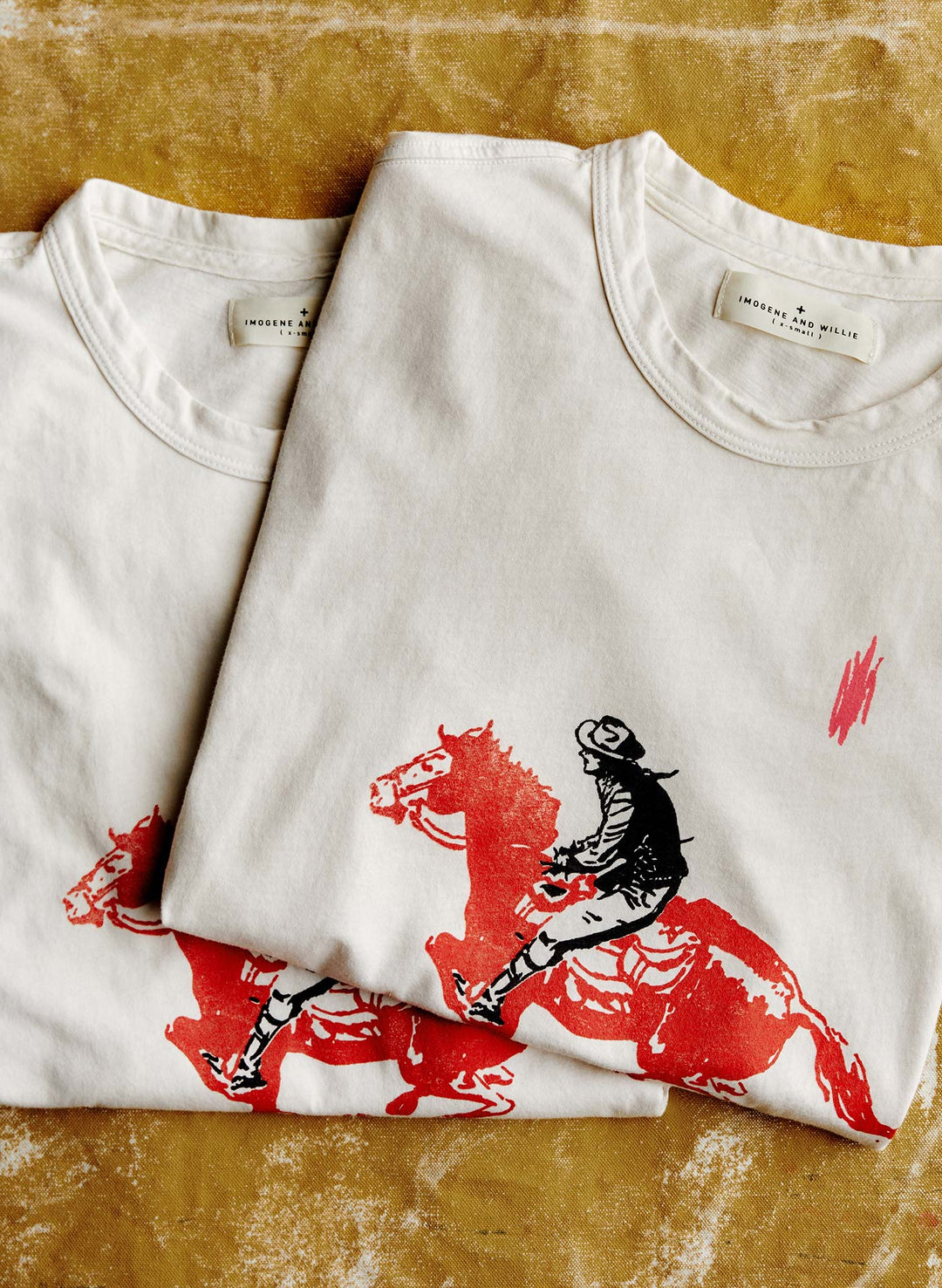 a white t-shirt with a horse design on it