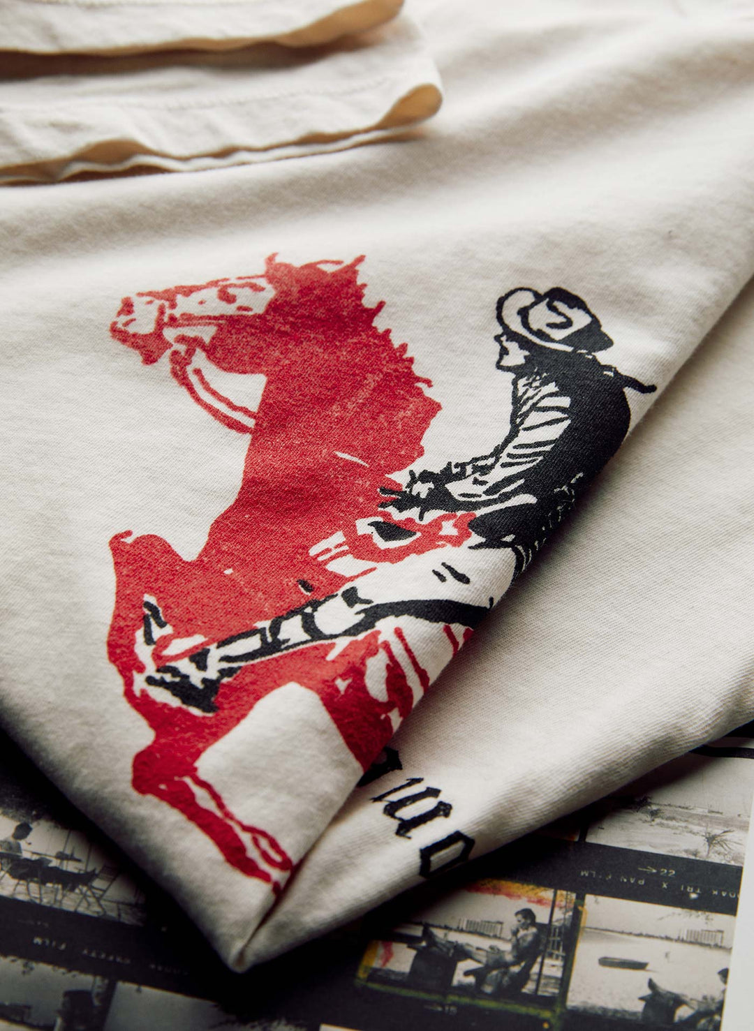 a white and red cloth with a horse and rider on it