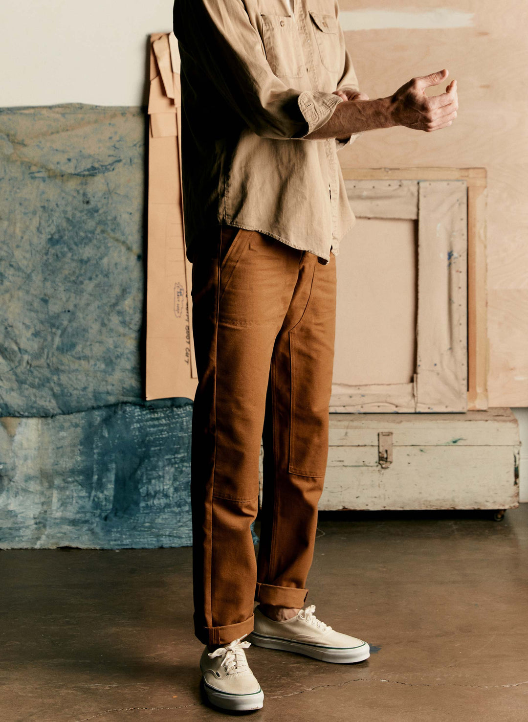 a man in brown pants and a brown shirt
