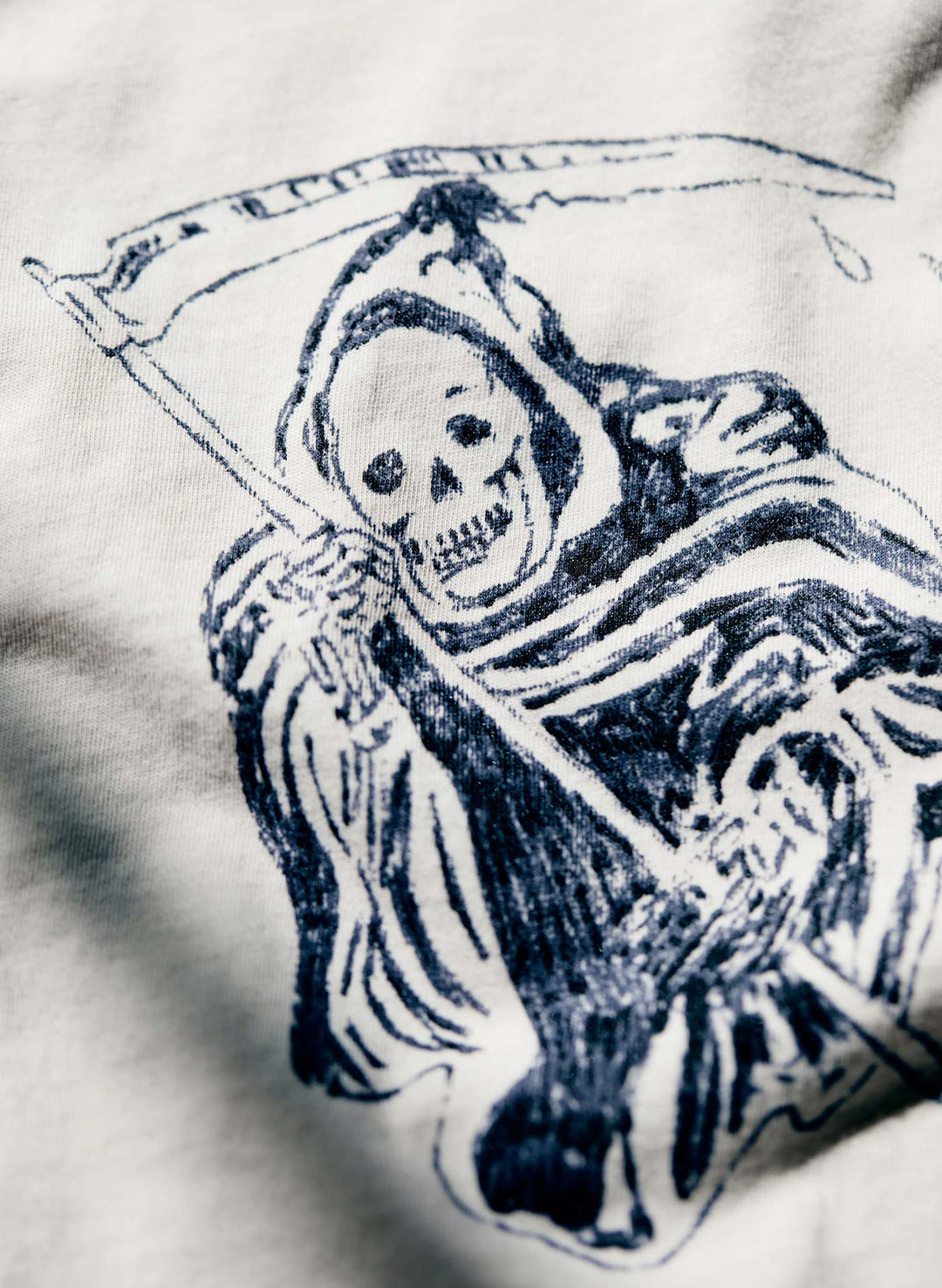 a drawing of a skeleton on a white fabric