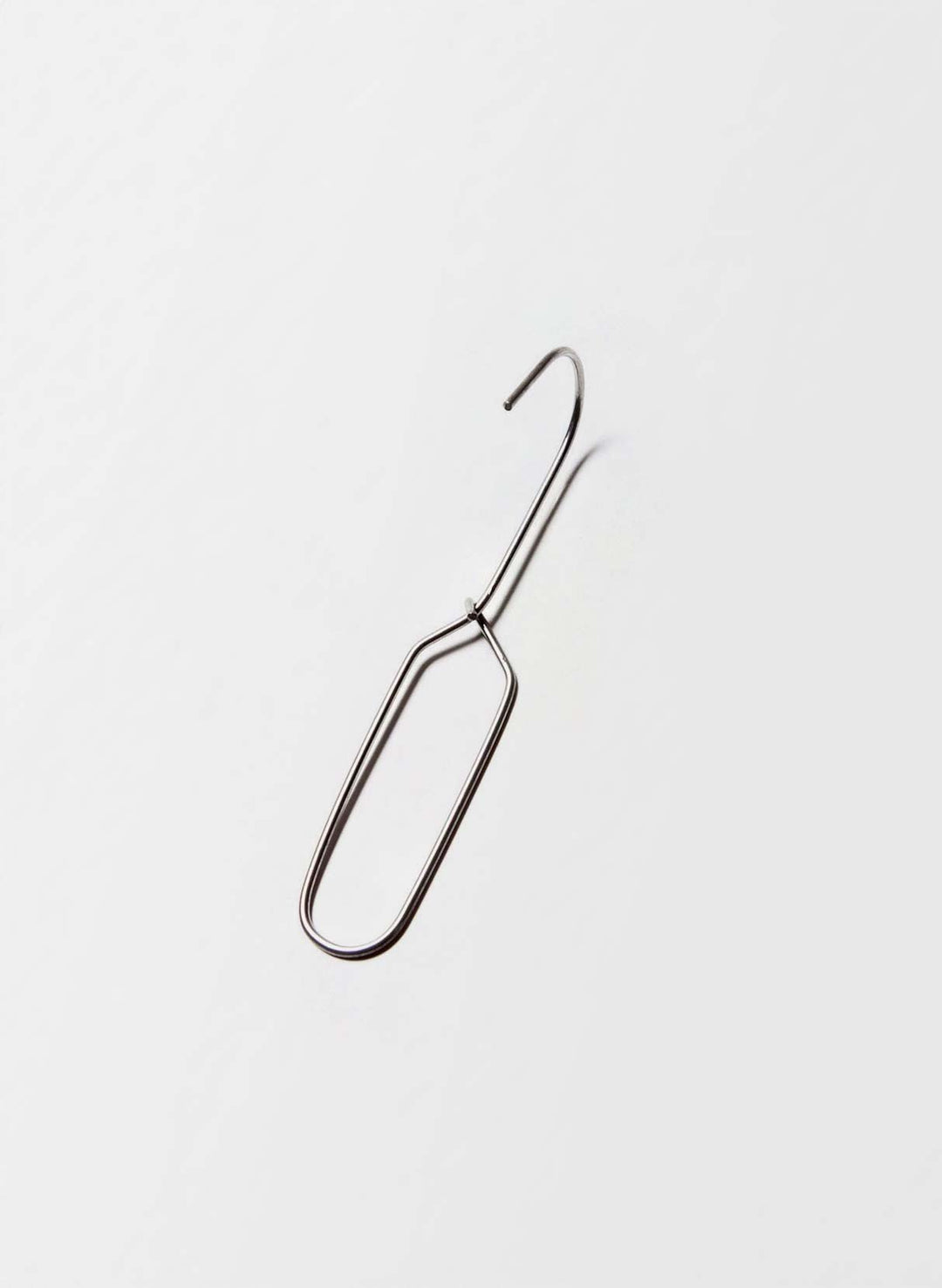 a silver hook on a white background