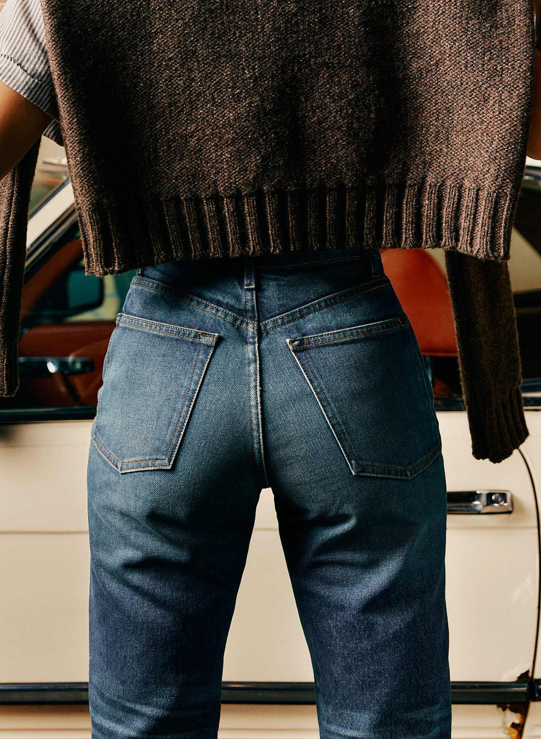 a person wearing jeans and a sweater