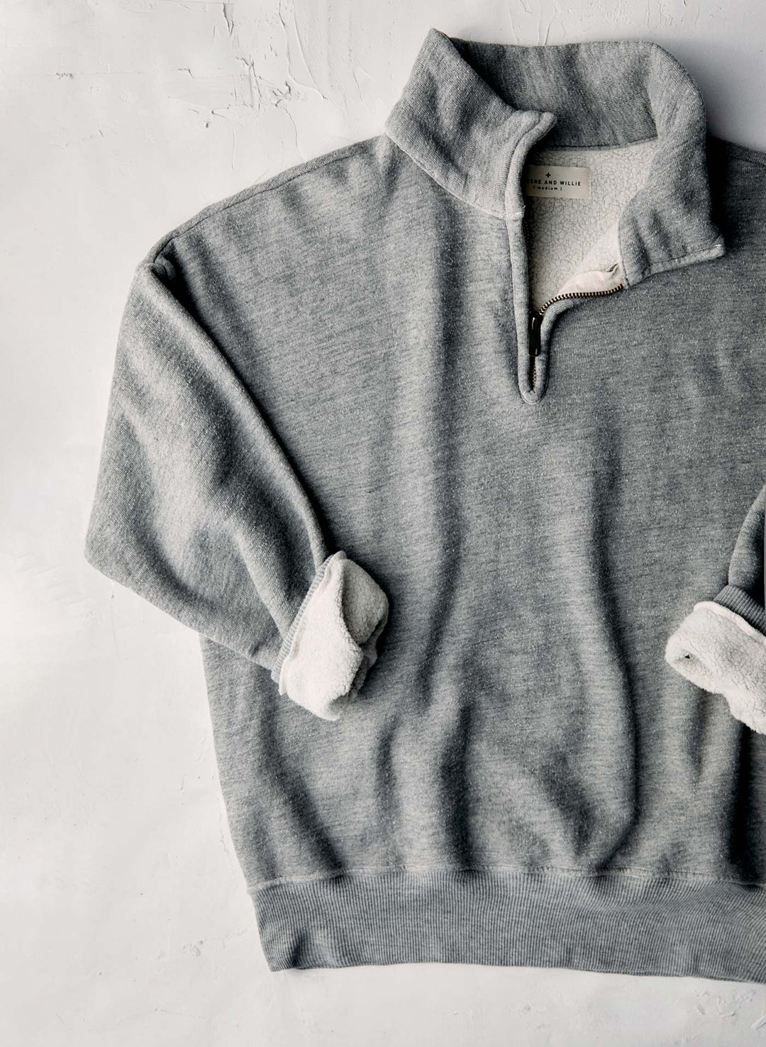 a grey sweater with a zipper