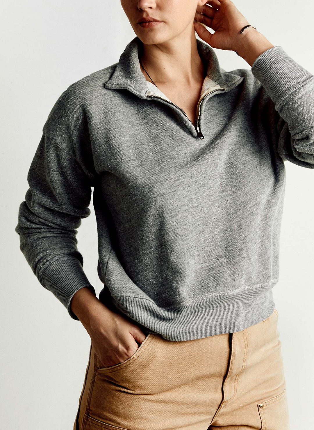 a woman in a grey sweater